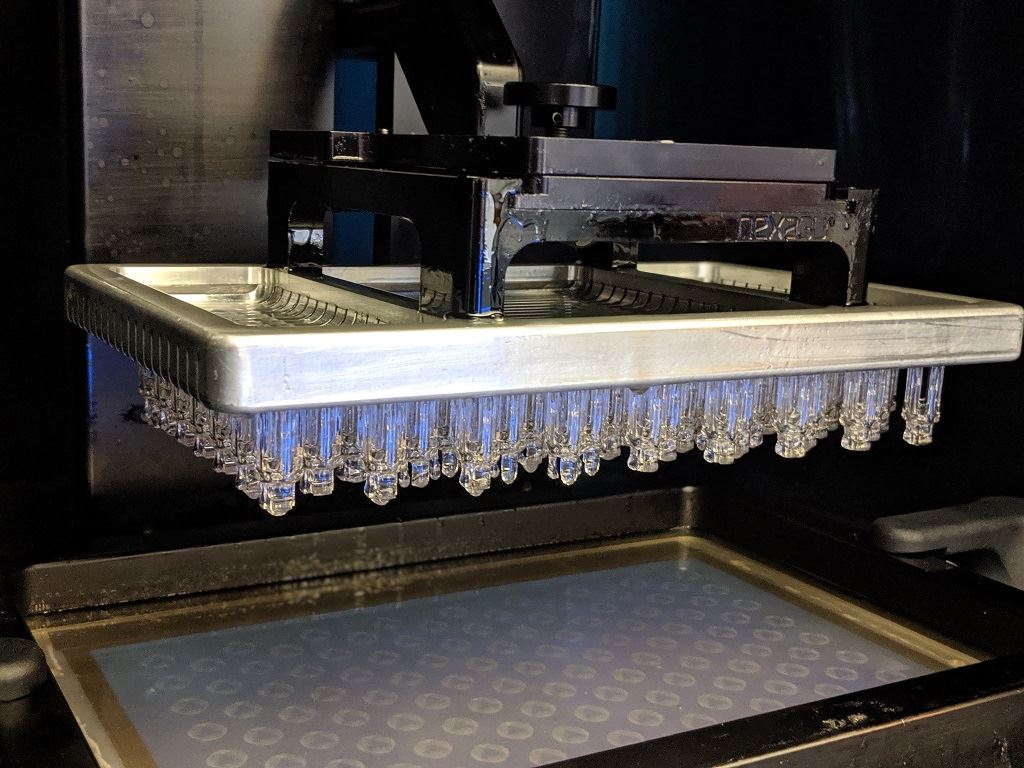  Freshly printed clips arise from an NXE 400 3D printer [Image: Fabbaloo] 