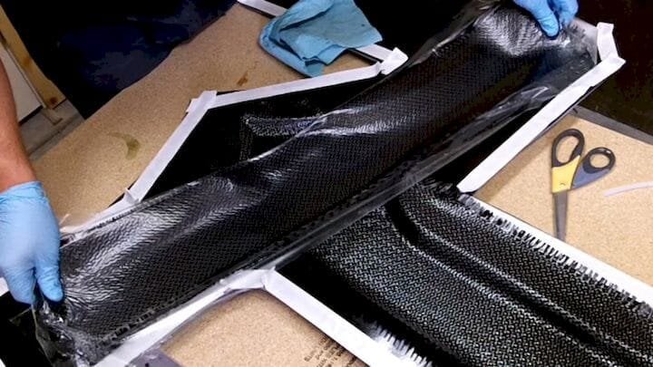  Pieces of carbon fiber being laid into a mold that will be filled with epoxy resin and vacuum sealed. (Image courtesy of The Project Junkie.) 