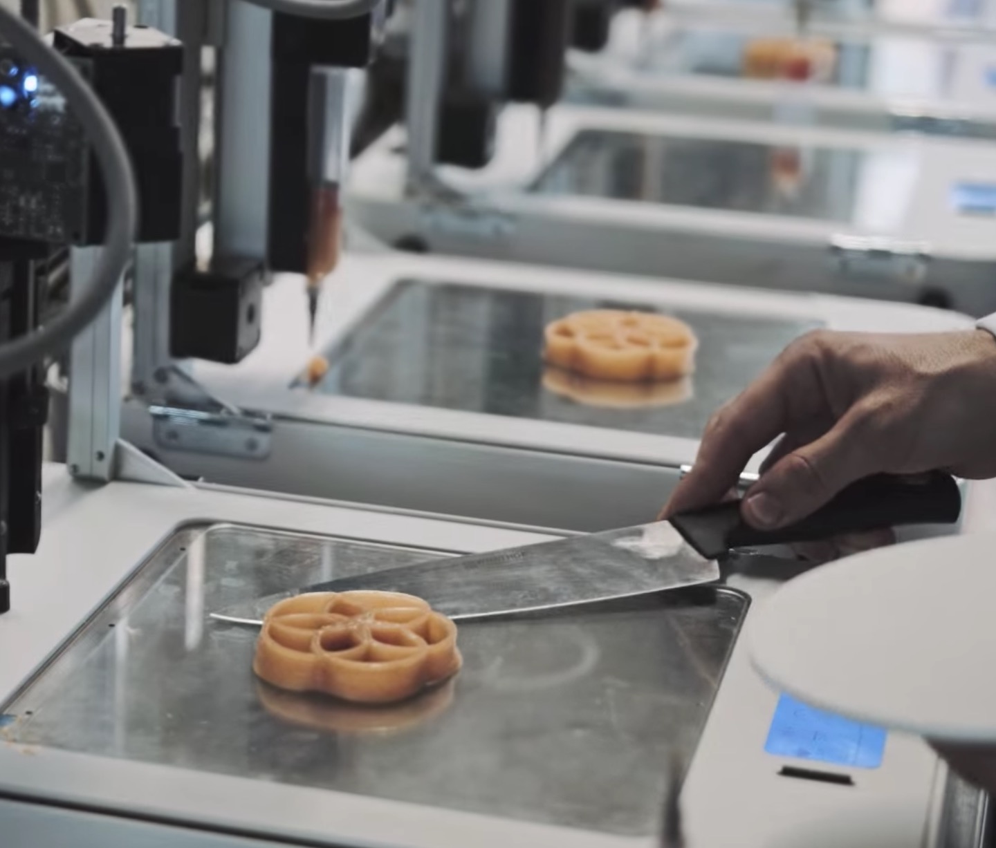  Removing a 3D printed food item from the machine 