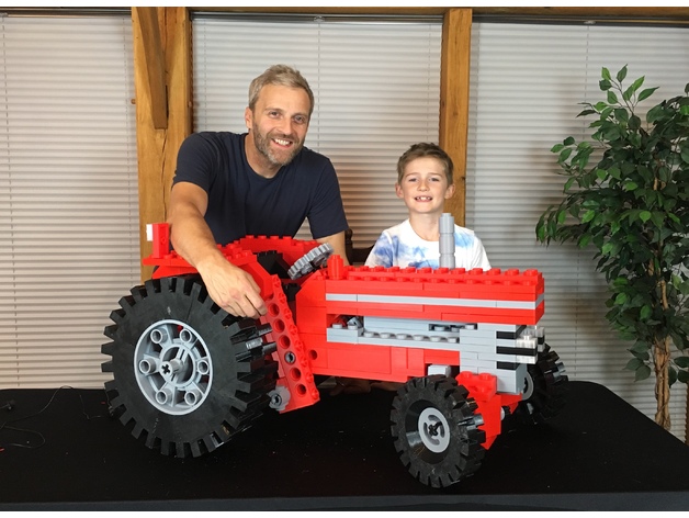  Matt Denton, his nephew Ruben, and their giant 3D printed LEGO tractor [Image: Matt Denton via Thingiverse] 