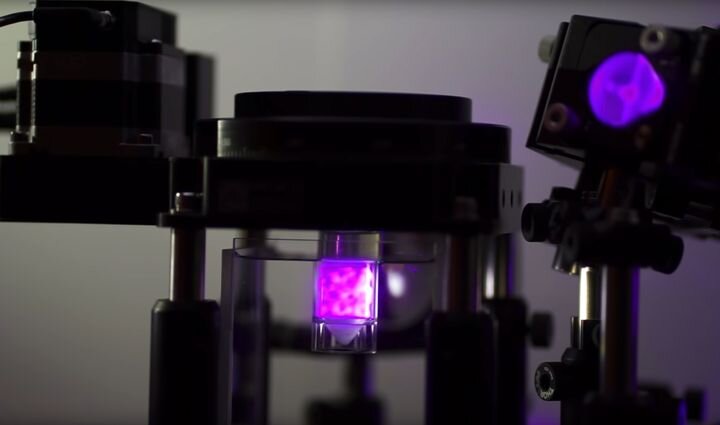  View of Readily3D’s volumetric 3D printer, with illuminated build chamber in the center [Source: Readily3D] 