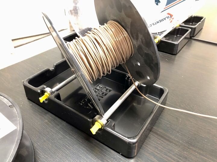  Lightweight filament spool being pulled off the not-so-great Prusa MMU2S spool holders [Source: Fabbaloo] 