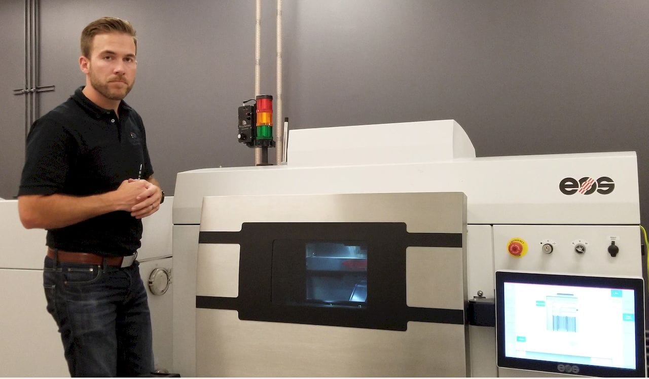  Matthew Gale showing a real-time sensor installed on an EOS metal 3D printer [Source: Polysense Solutions] 