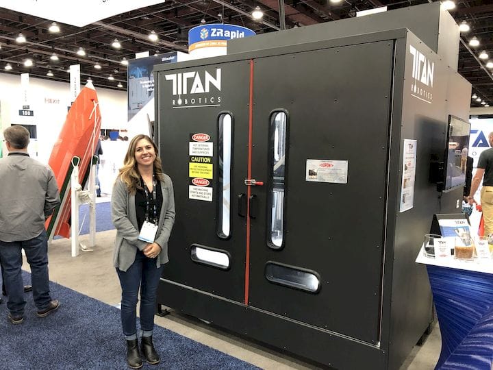  A large-format 3D printer from Titan Robotics, with co-Founder Maddie Guillory for scale [Source: Fabbaloo] 