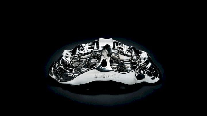  A 3D-printed brake caliper that is thought to be featured in Bugatti’s latest luxury vehicle, the $12.5M La Voiture Noire. (Image courtesy of Bugatti.) 