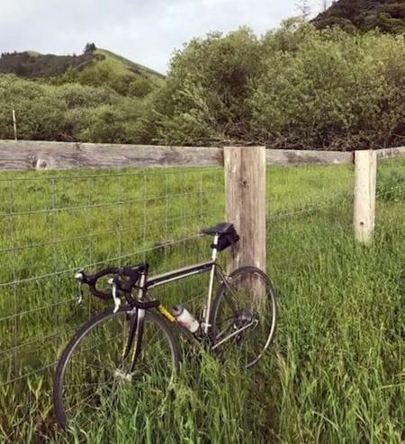  Splendor in the grass. The author's bike rests during a recent trip through Marin County, Calif. The diamond-shaped bike frame with tubular construction may be the optimum shape. Made of titanium, this bike has withstood a hundred thousand miles. It will, without a doubt, outlast and outlive its owner. 
