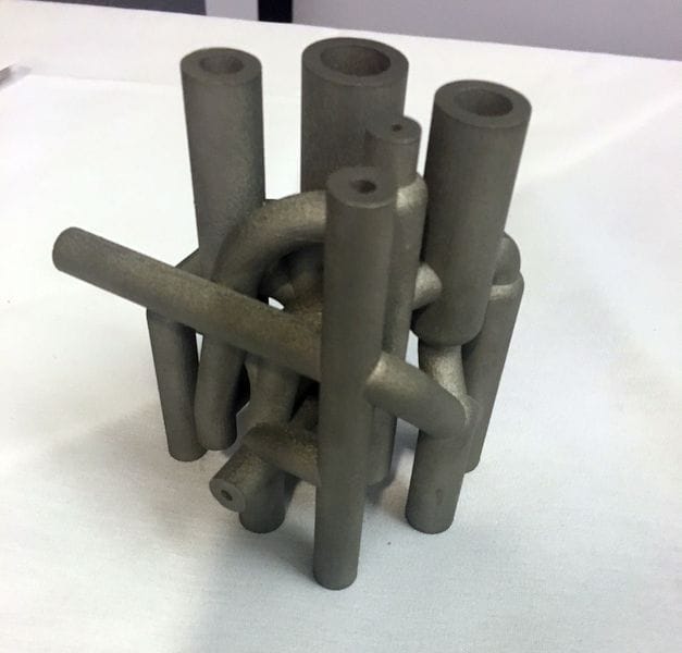  AddUp showing off a 3D printed metal part At the 13th Additive International Conference 