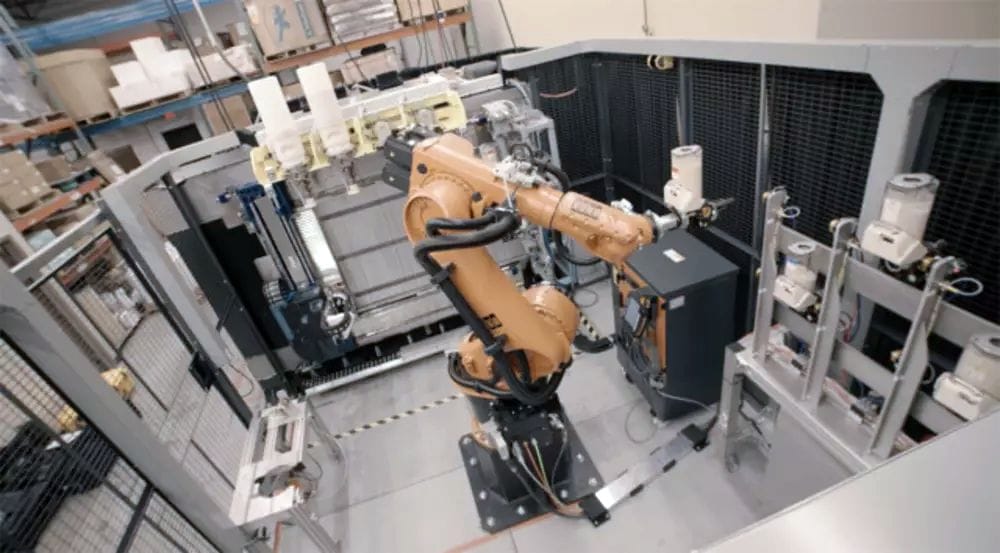  An industrial robotic arm can swap out used pellet containers or tool heads in Stratasys’ Infinite Build Demonstrator. (Image courtesy of Stratasys.) 