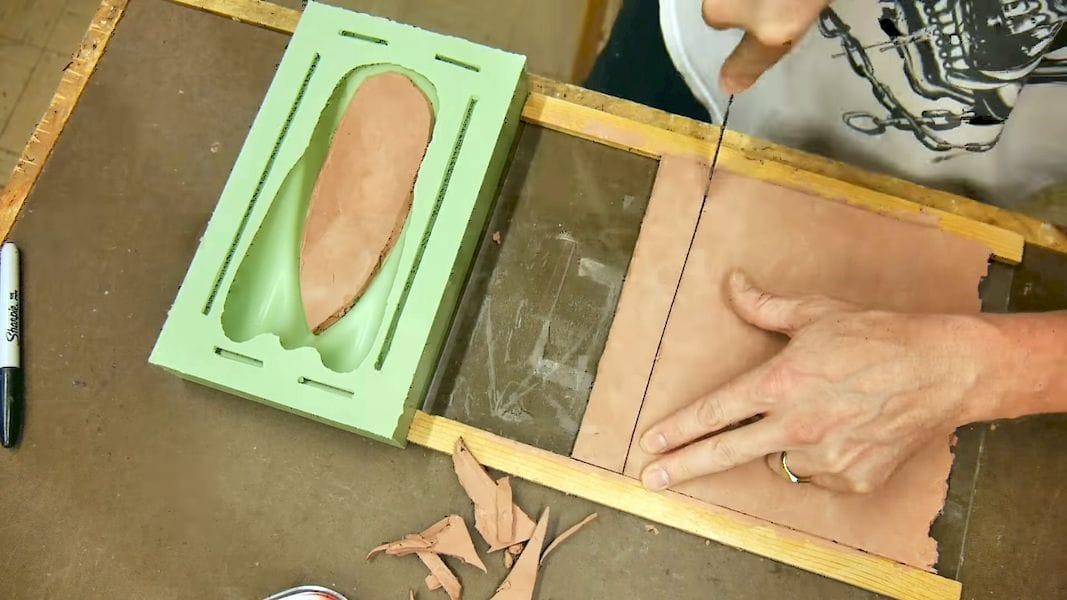  Cutting clay pieces to form the thin wall 