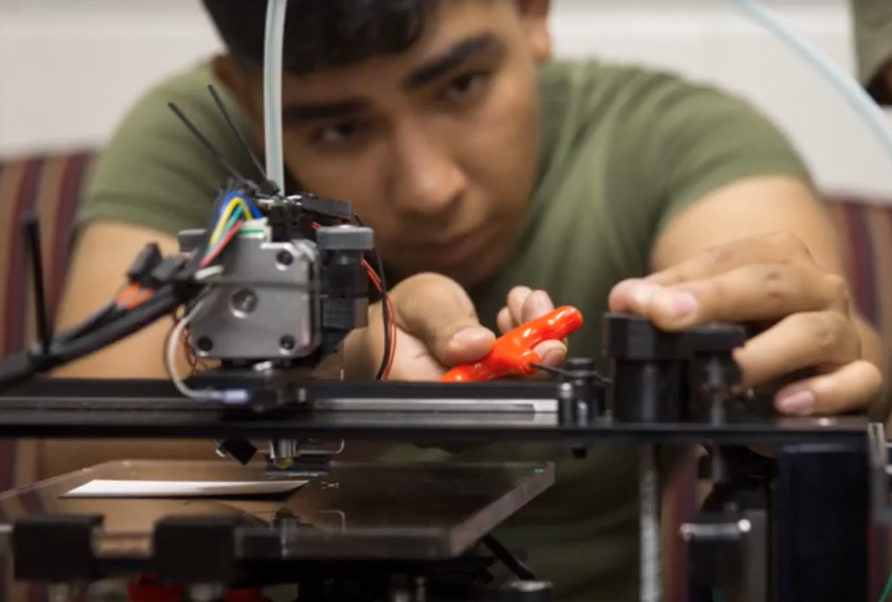  A US Marine working in the X-FAB, a prototype mobile 3D print workshop 