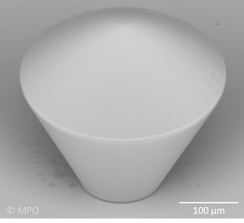  3D printed aspheric lens (diameter 100 micron) on a conical base, total height app. 65 micron, lens app. 22 micron, roughness Ra app. 20 nm 