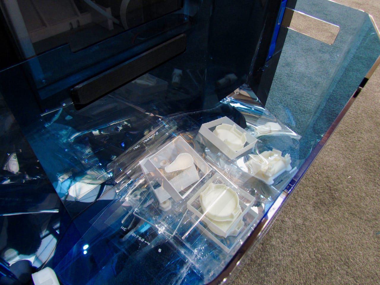  Multiple completed 3D print build sheets in the blue bin on Stratasys' Continuous Build Demonstrator 