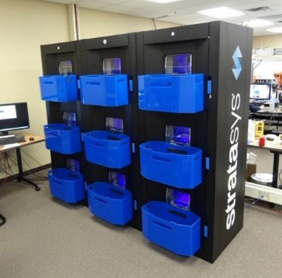  Stratasys' new continuous 3D printing concept demonstrator. Note blue bins to catch prints! 