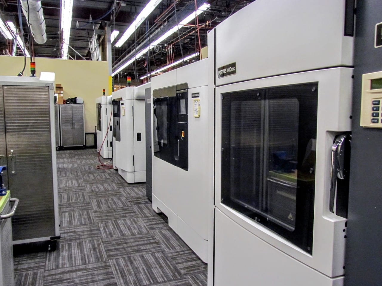  A row of production Stratasys Fortus 3D printers 