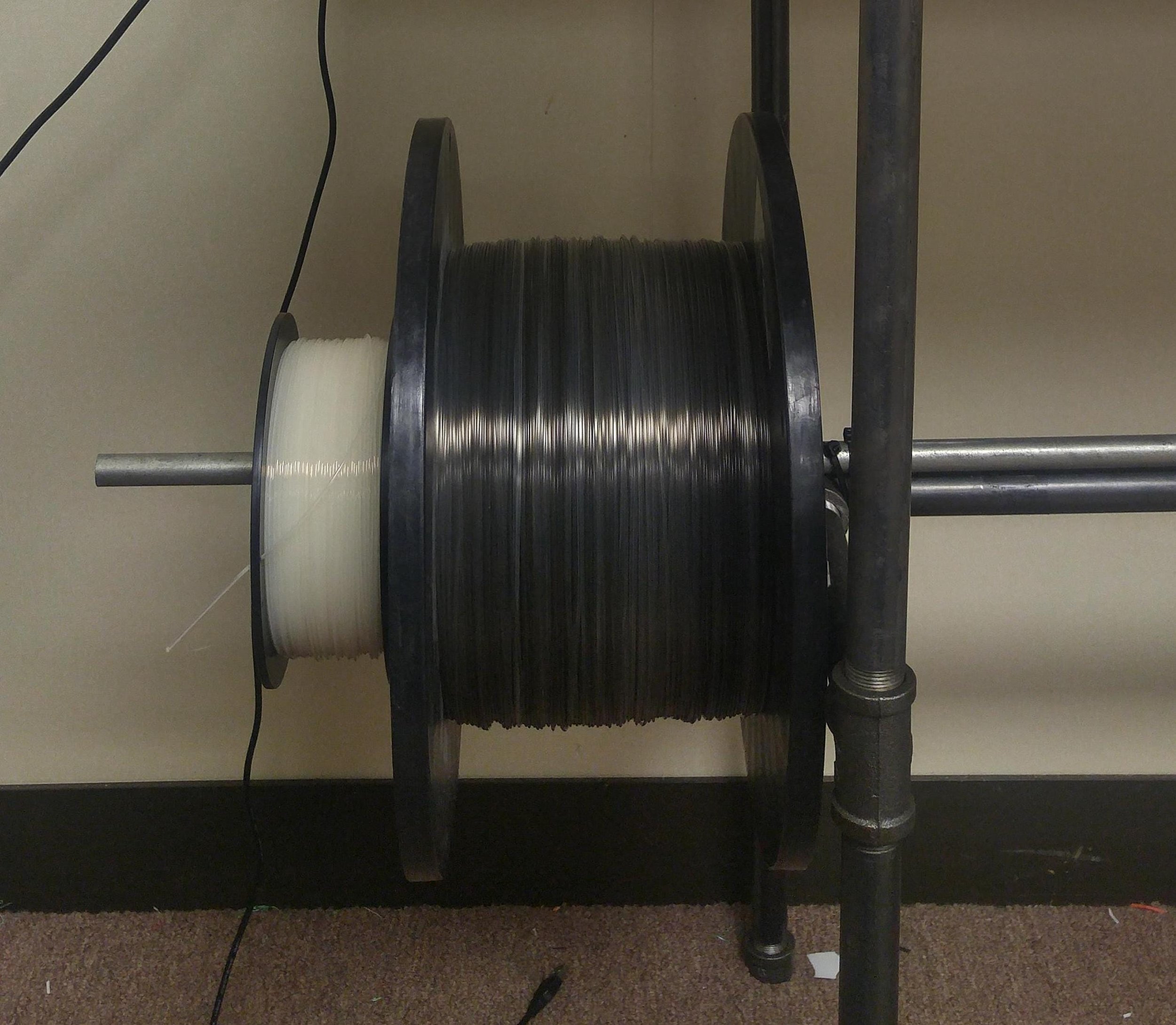  A gigantic 5mm diameter 3D printer filament beside a standard 1kg spool 