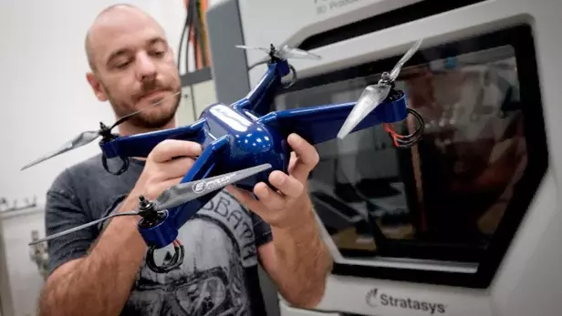  Keane holding his drone, 3D-printed in ULTEM with embedded electronics. (Image courtesy of Stratasys.) 