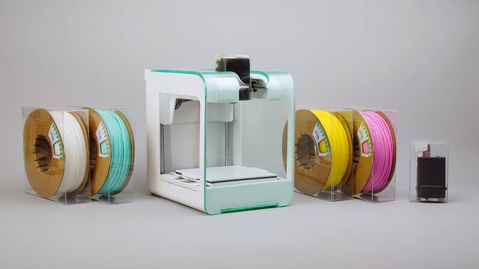 The PocketMaker desktop 3D printer with associated tiny spools of filament 