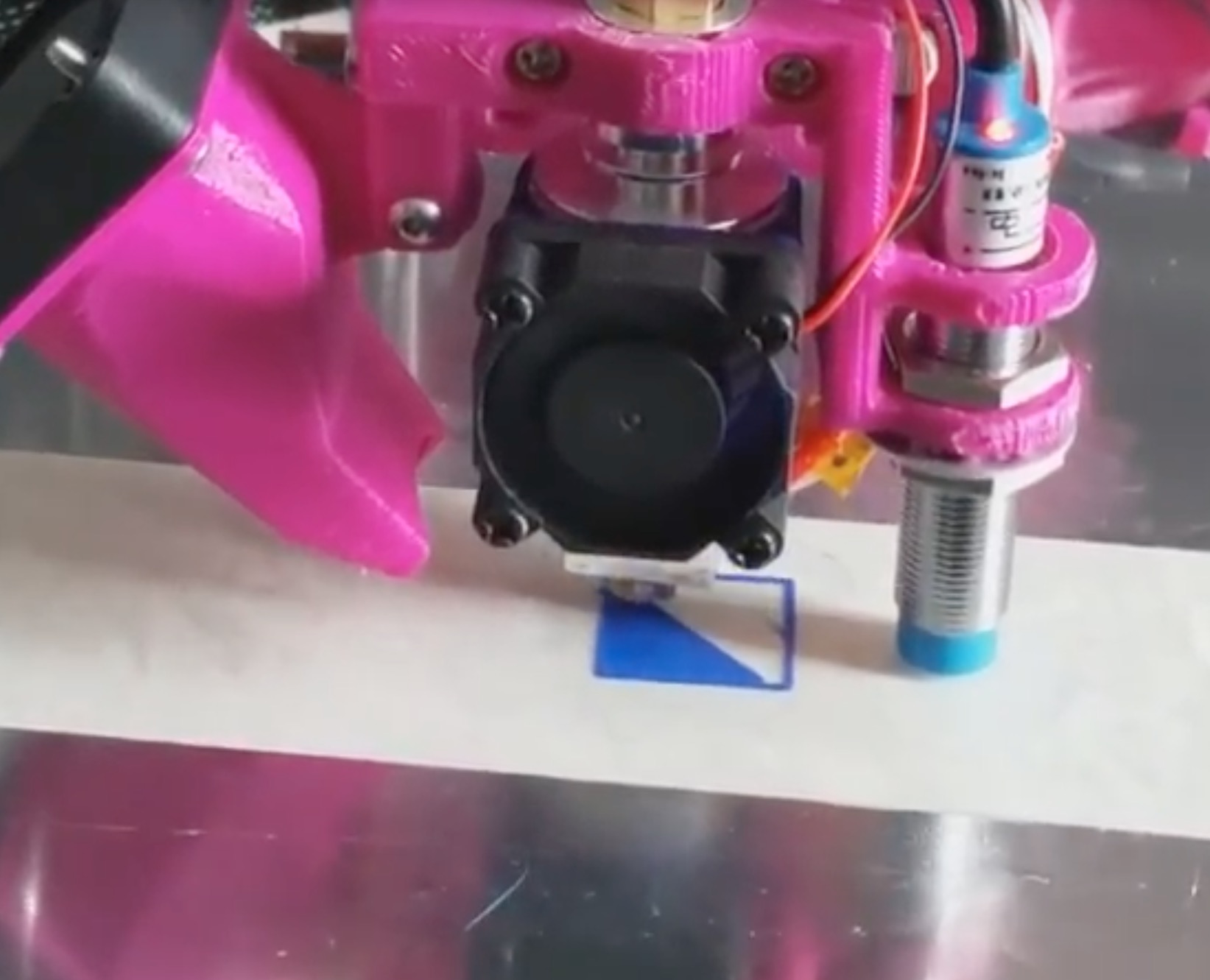  The Go-Make Junior 3D printing. Note the auto-leveling sensor on the right 