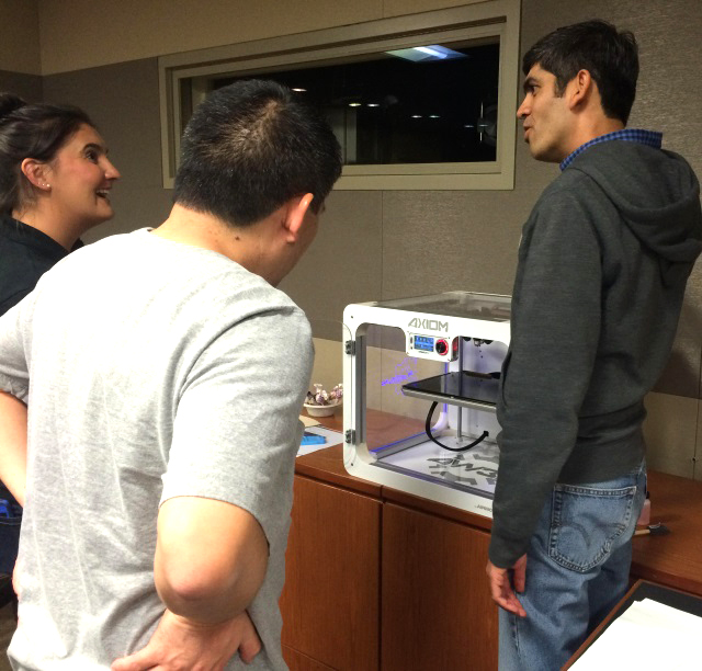  Individuals happily discovering 3D printing at Airwolf's Warner Bros. 3D print event 