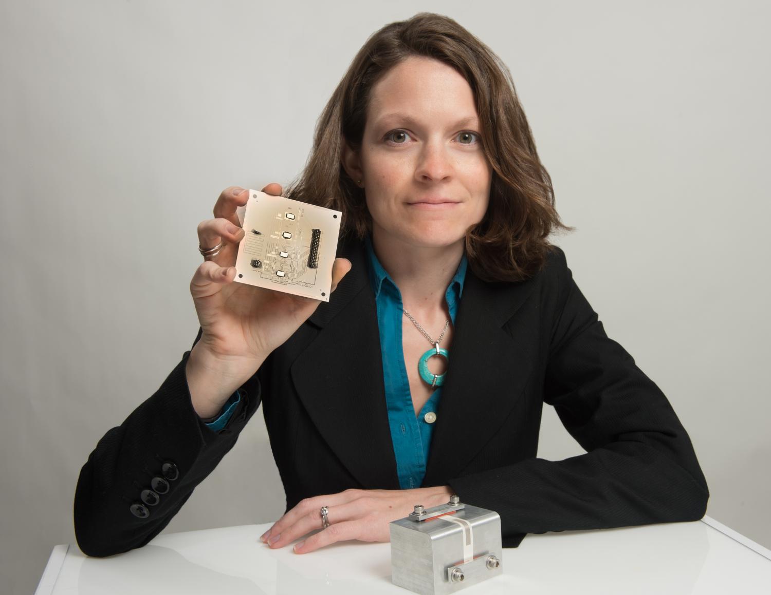  NASA Goddard technologist Beth Paquette shows a 3D printed object including circuit paths 