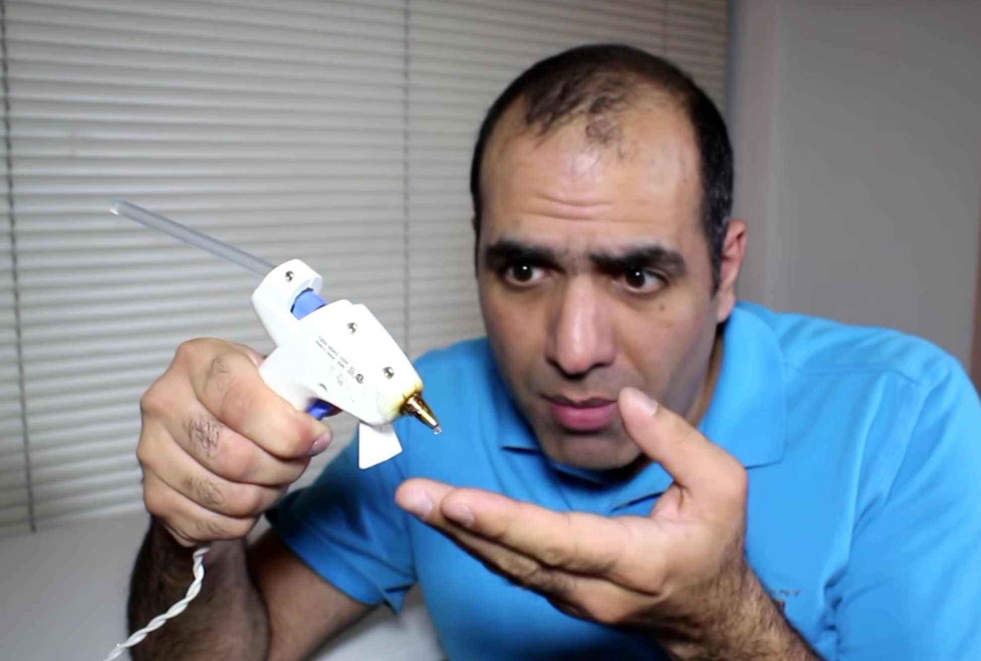  Mehdi Sadaghdar demonstrating how a glue gun is similar to 3D printing 