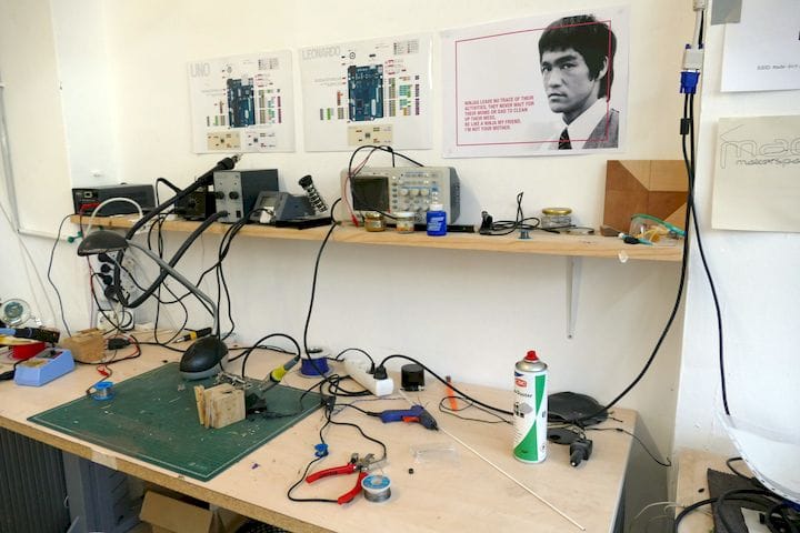  Electronics workbench complete with poster of Bruce Lee telling you to clean up after yourself. 