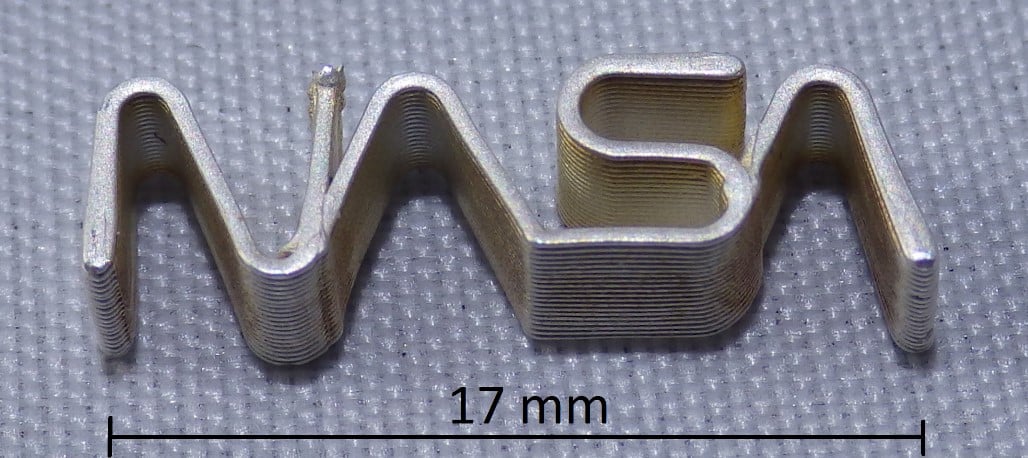 Printed silver NASA logo with 0.5 mm wall thickness from 2011 [Image: nScrypt] 