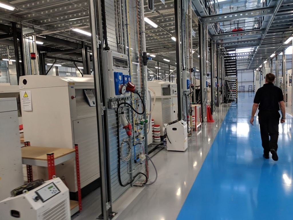  Phil Hatherley, General Manager, Materials Solutions,  leads the way through the 3D printing floor at the Materials Solutions facility  in the UK [Image: Sarah Goehrke/Fabbaloo] 